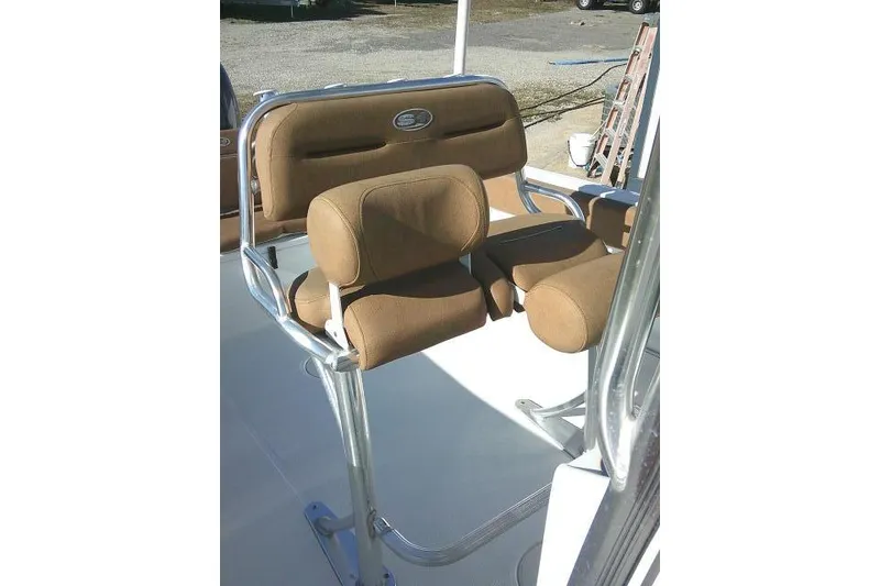 Slide: The Image of 2023 Sea Hunt Ultra 234 boat seating with brown cushions and metal frame. - 27