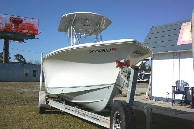 Slide: The Image of 2023 Sea Hunt Ultra 234 boat on trailer, parked outdoors. - 3