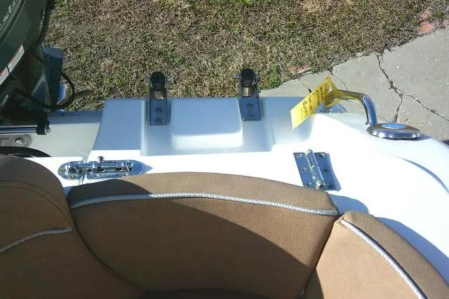 Slide: The Image of 2023 Sea Hunt Ultra 234 boat interior with tan seating and metal fixtures. - 32