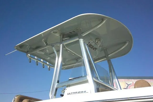 Slide: The Image of 2023 Sea Hunt Ultra 234 boat with T-top against clear blue sky. - 5