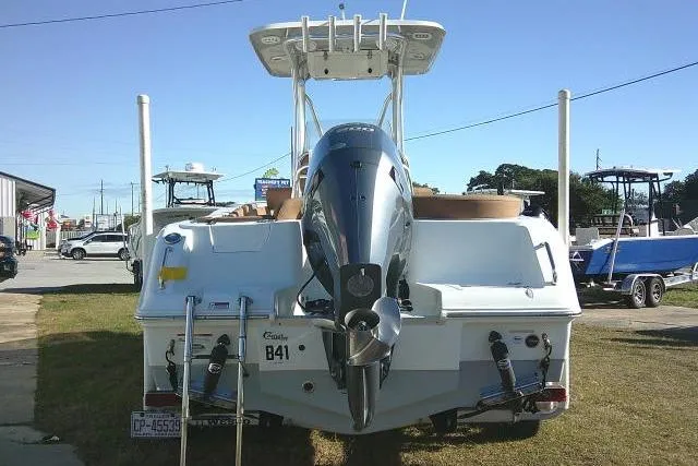 Slide: The Image of 2023 Sea Hunt Ultra 234 boat, rear view with outboard motor, parked on grass. - 8
