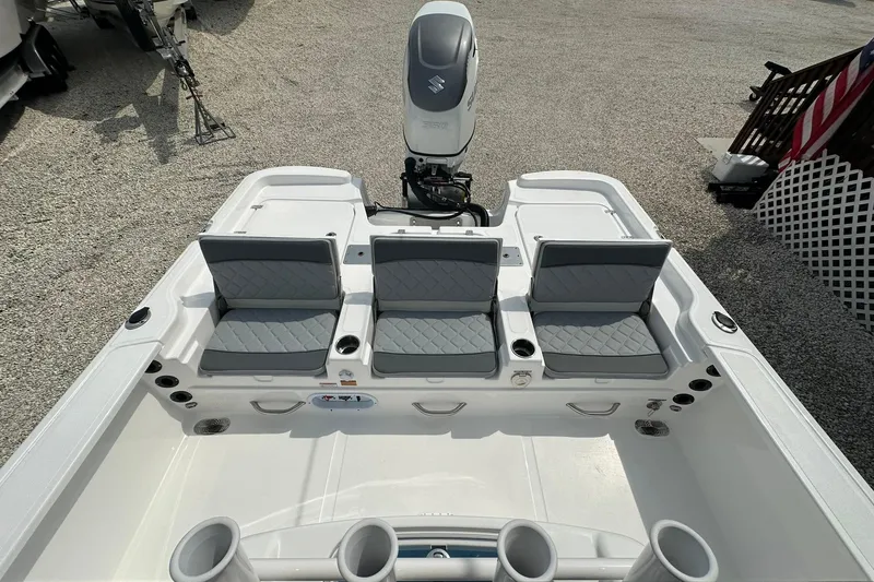 Slide: The Image of 2024 NauticStar 274 Bay boat interior with seating and motor, showcasing modern design. - 13