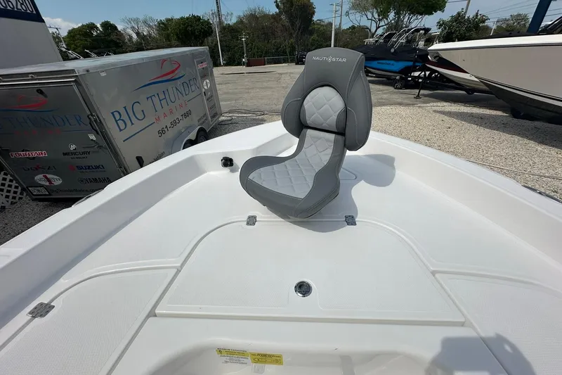 Slide: The Image of 2024 NauticStar 274 Bay boat with a sleek gray seat on deck. - 15