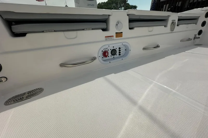 Slide: The Image of 2024 NauticStar 274 Bay boat interior with seating, controls, and speaker. - 18