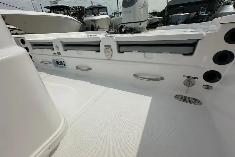 Slide: The Image of 2024 NauticStar 274 Bay boat interior with storage compartments and utility features. - 19