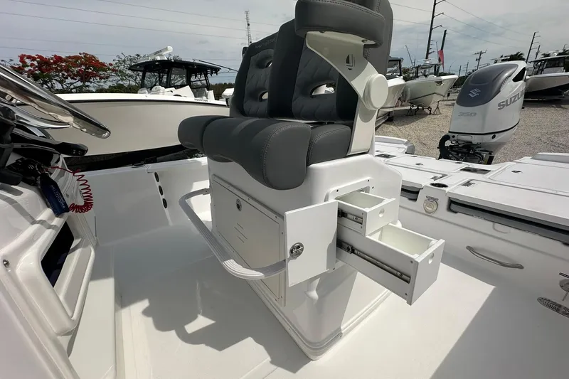 Slide: The Image of 2024 NauticStar 274 Bay boat interior with storage drawers and seating. - 20