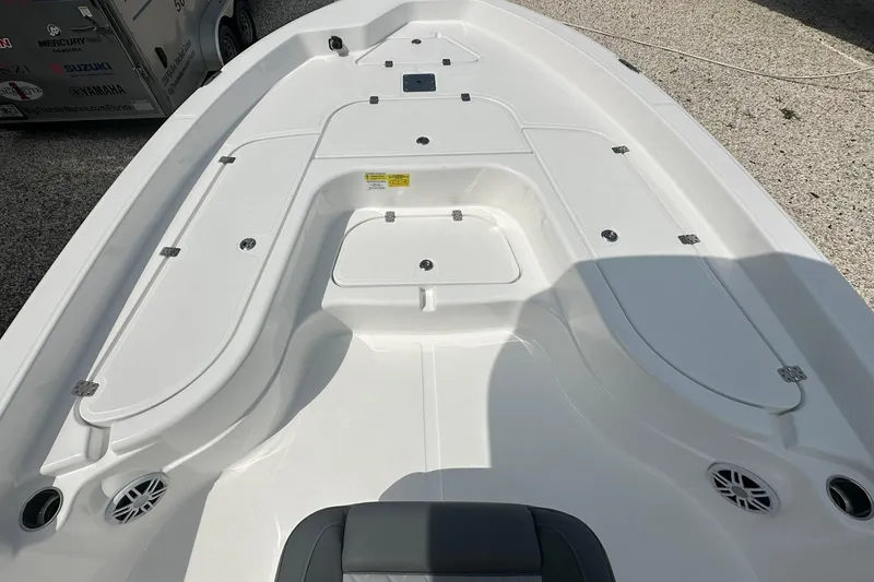 Slide: The Image of 2024 NauticStar 274 Bay boat deck with storage compartments and speakers. - 3