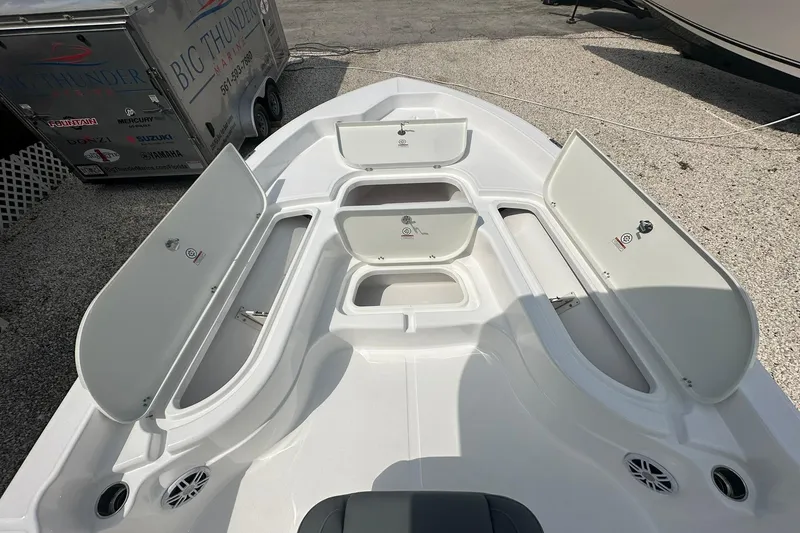 Slide: The Image of 2024 NauticStar 274 Bay boat with open storage compartments on deck. - 4