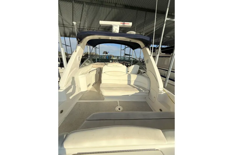 Slide: The Image of 2001 Sea Ray 340 Sundancer boat interior with seating under a covered dock. - 11