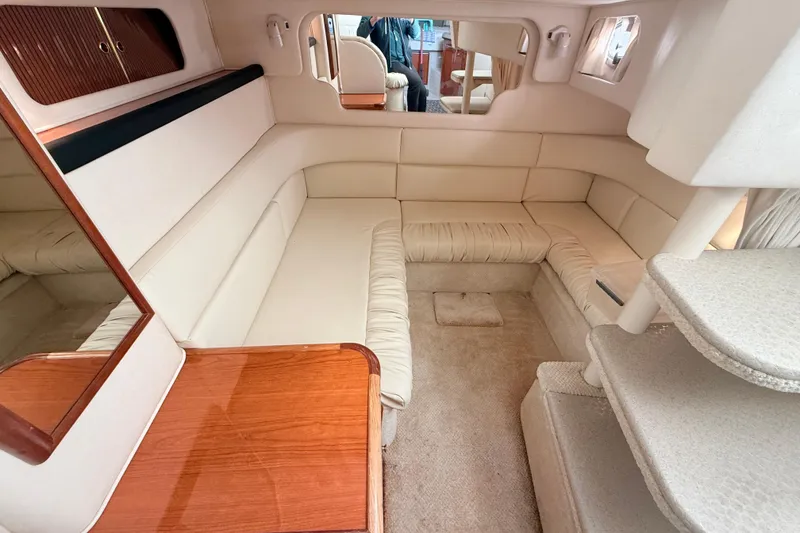 Slide: The Image of Interior of 2001 Sea Ray 340 Sundancer yacht with beige seating and wooden accents. - 19