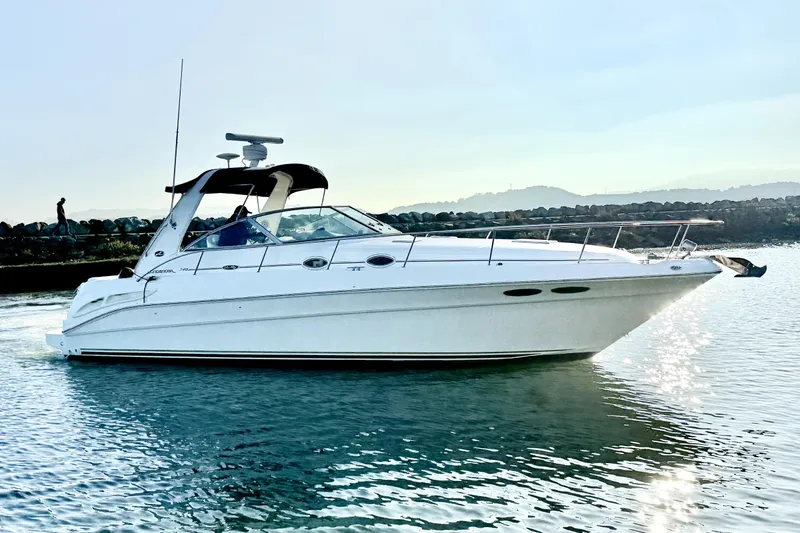 Slide: The Image of 2001 Sea Ray 340 Sundancer yacht cruising on calm water. - 2