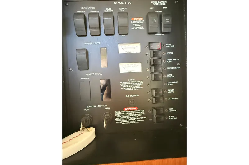 Slide: The Image of Control panel of a 2001 Sea Ray 340 Sundancer boat, showing various switches and indicators. - 26