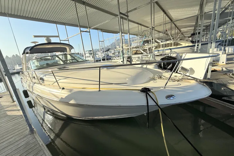 Slide: The Image of 2001 Sea Ray 340 Sundancer docked in a marina under a covered structure. - 7