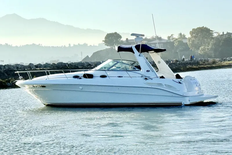 The Image of 2001 Sea Ray 340 Sundancer yacht cruising on calm waters with scenic background. - 0
