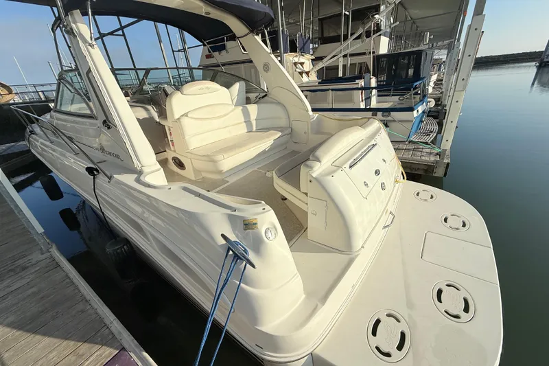 Slide: The Image of 2001 Sea Ray 340 Sundancer docked, showcasing spacious deck and seating area. - 10