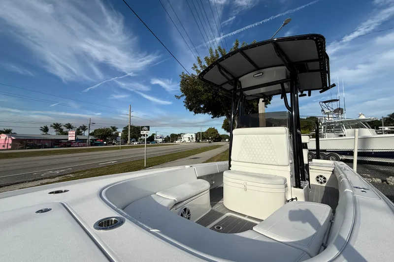 Slide: The Image of 2021 Contender 25 Bay boat with T-top, parked near a road under a clear sky. - 16
