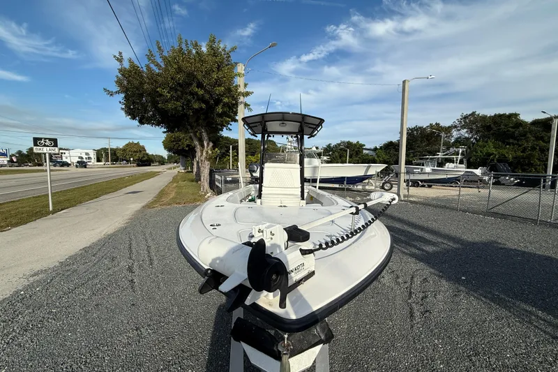 Slide: The Image of 2021 Contender 25 Bay boat parked on gravel near a road and bike lane. - 17