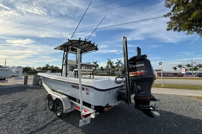 Slide: The Image of 2021 Contender 25 Bay boat with Yamaha engine on trailer, parked outdoors. - 4