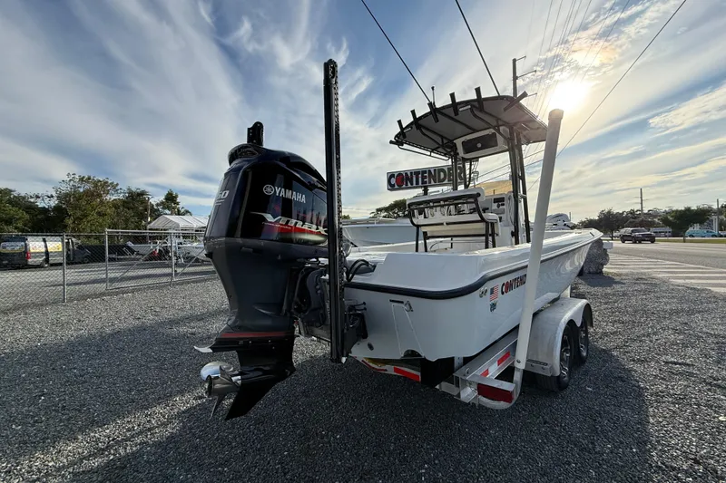 Slide: The Image of 2021 Contender 25 Bay boat with Yamaha engine on trailer, parked outdoors. - 5