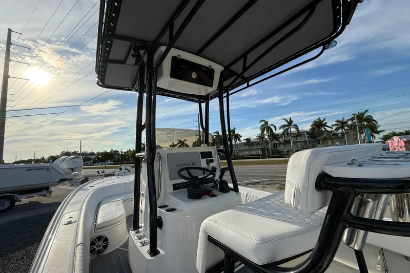 Slide: The Image of 2021 Contender 25 Bay boat interior with Garmin system, under a clear sky. - 6