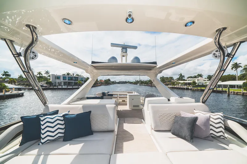 Slide: The Image of Luxurious 2017 Sea Ray L650 Fly yacht interior with plush seating and scenic waterfront view. - 14