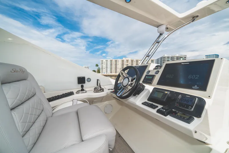Slide: The Image of 2017 Sea Ray L650 Fly yacht helm with modern controls and luxurious seating. - 17
