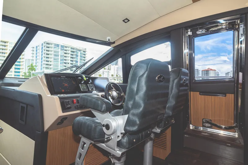 Slide: The Image of Interior helm of 2017 Sea Ray L650 Fly yacht with modern controls and seating. - 22