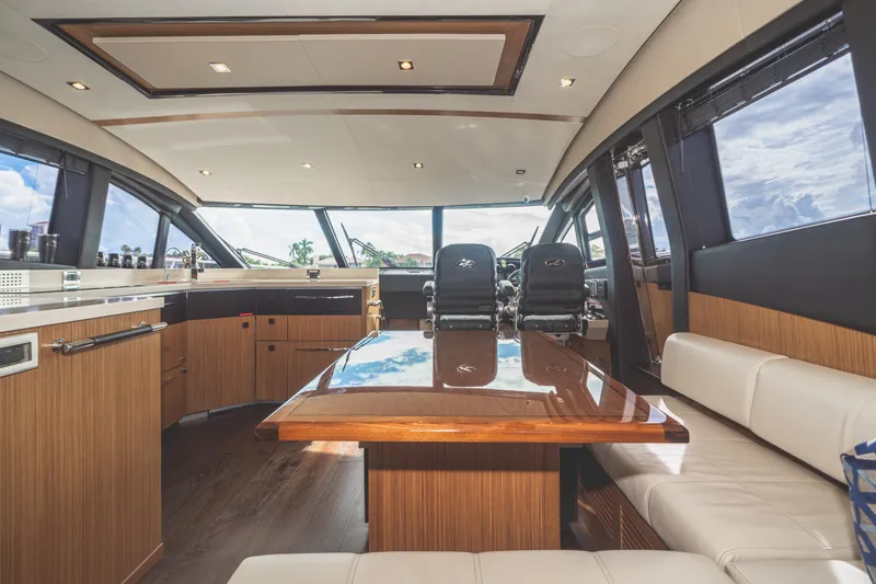 Slide: The Image of Luxurious interior of 2017 Sea Ray L650 Fly yacht with modern wood finishes and panoramic windows. - 29
