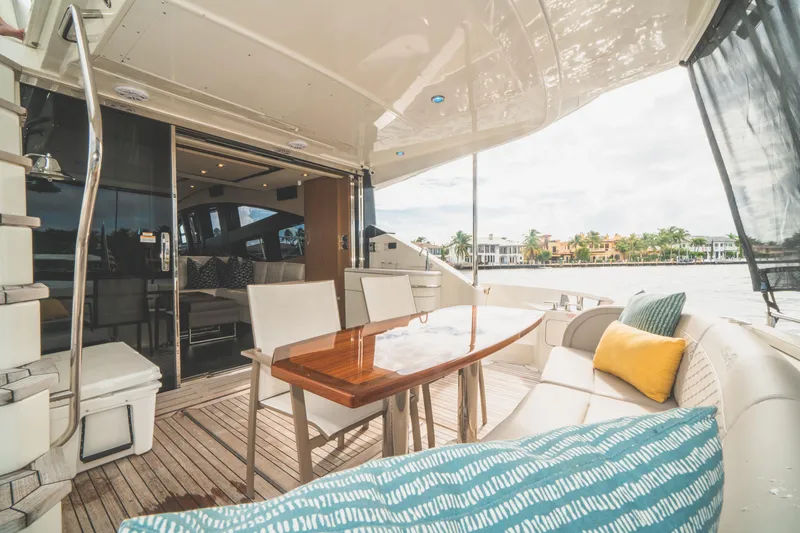 Slide: The Image of Luxurious 2017 Sea Ray L650 Fly yacht with elegant outdoor seating and scenic waterfront view. - 35