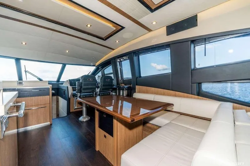 Slide: The Image of Luxurious interior of 2017 Sea Ray L650 Fly yacht with modern seating and panoramic windows. - 4