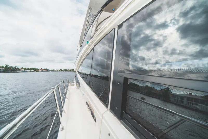 Slide: The Image of 2017 Sea Ray L650 Fly yacht reflecting cloudy sky on calm waters. - 40