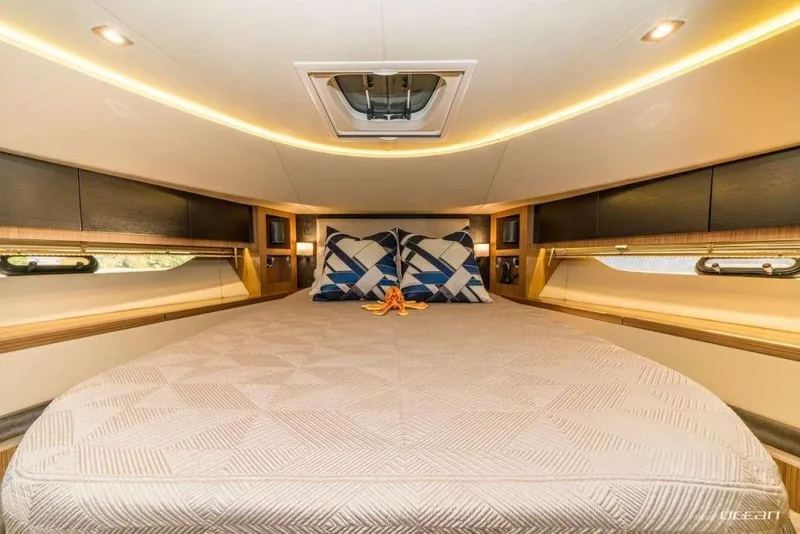 Slide: The Image of Luxurious 2017 Sea Ray L650 Fly yacht bedroom with elegant bedding and ambient lighting. - 7
