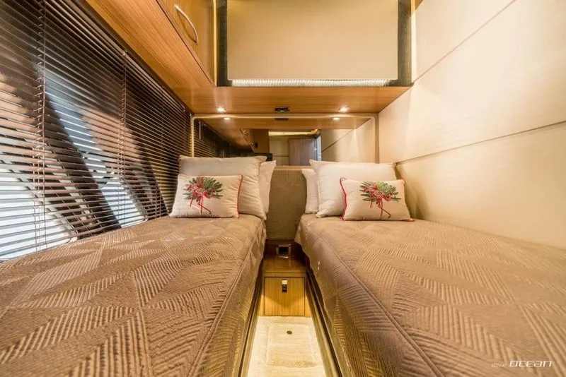 Slide: The Image of Luxurious twin cabin interior of 2017 Sea Ray L650 Fly yacht with elegant bedding. - 8