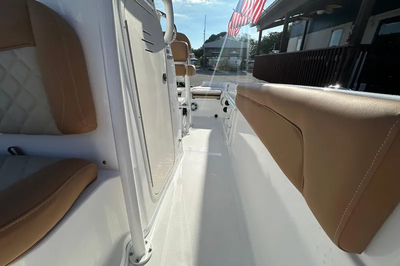 Slide: The Image of 2025 NauticStar 231 Hybrid boat interior with tan seating and sleek design. - 10
