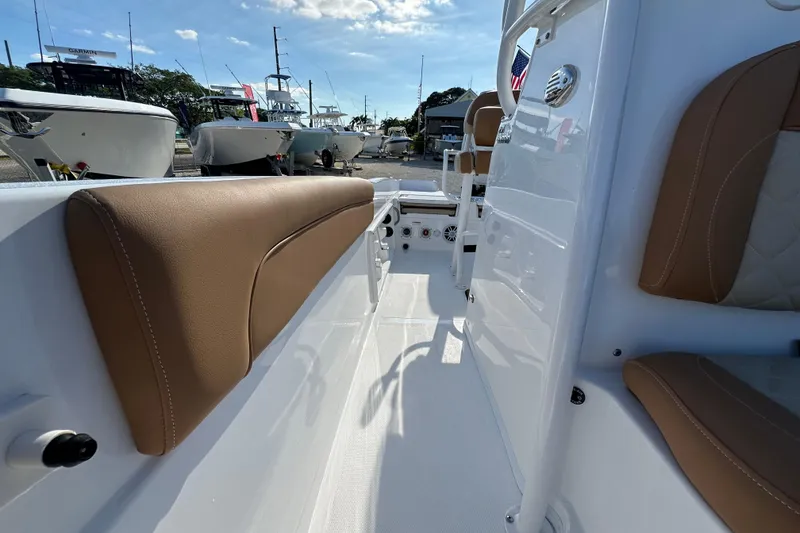 Slide: The Image of 2025 NauticStar 231 Hybrid boat interior with tan seating and sleek white design. - 11