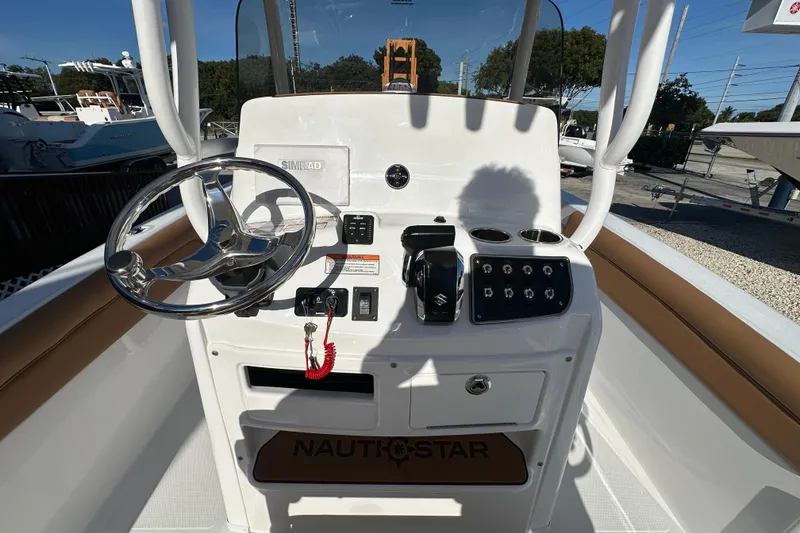 Slide: The Image of 2025 NauticStar 231 Hybrid boat console with steering wheel and controls. - 15