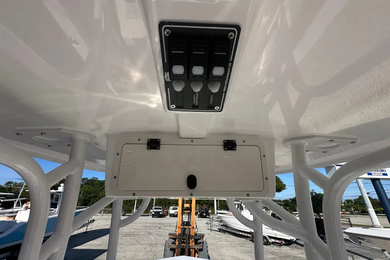 Slide: The Image of 2025 NauticStar 231 Hybrid boat console with control panel and storage compartment. - 16