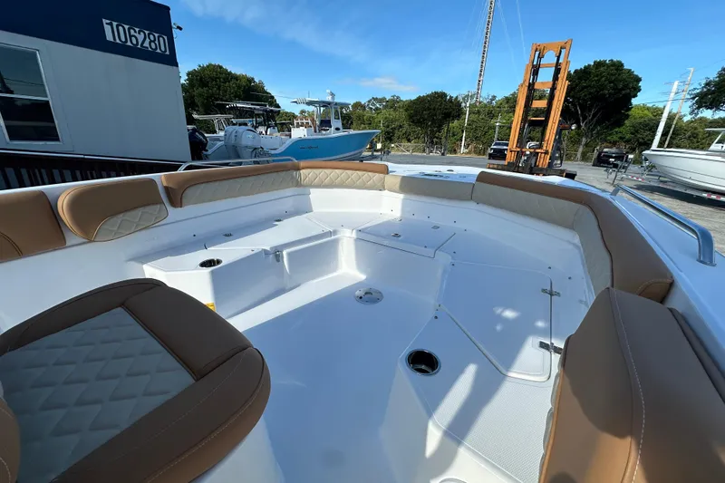 Slide: The Image of 2025 NauticStar 231 Hybrid boat interior with tan seating and spacious deck. - 7