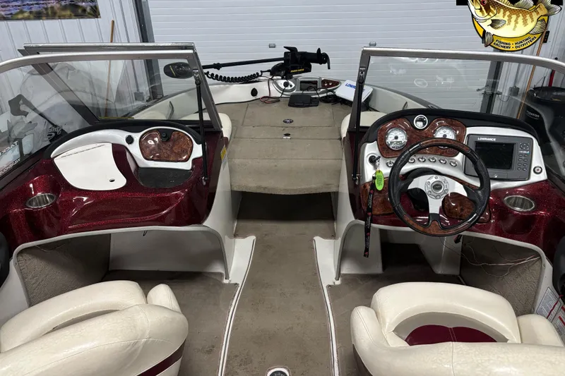 Slide: The Image of Interior of a 2009 Nitro 290 Sport boat with steering wheel and dashboard controls. - 10