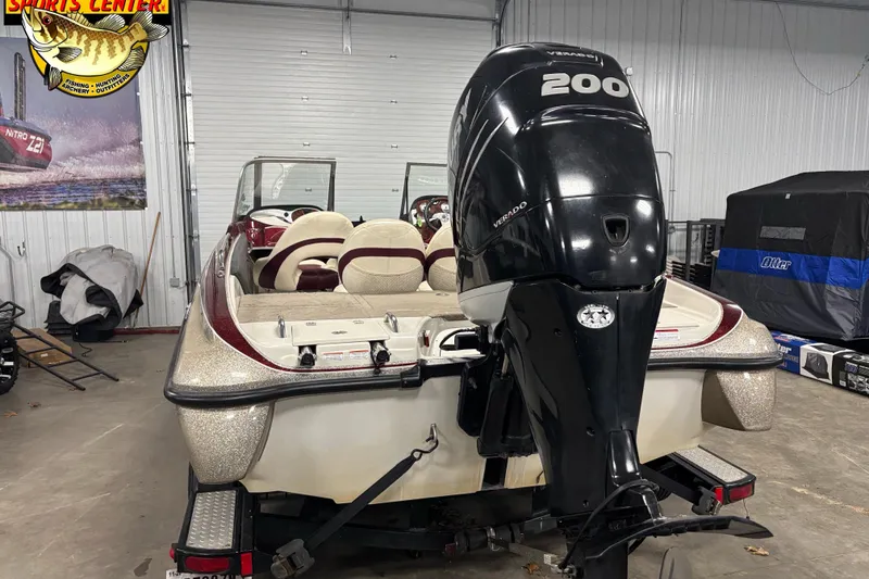 Slide: The Image of 2009 Nitro 290 Sport boat with powerful 200 Verado engine in a garage setting. - 3