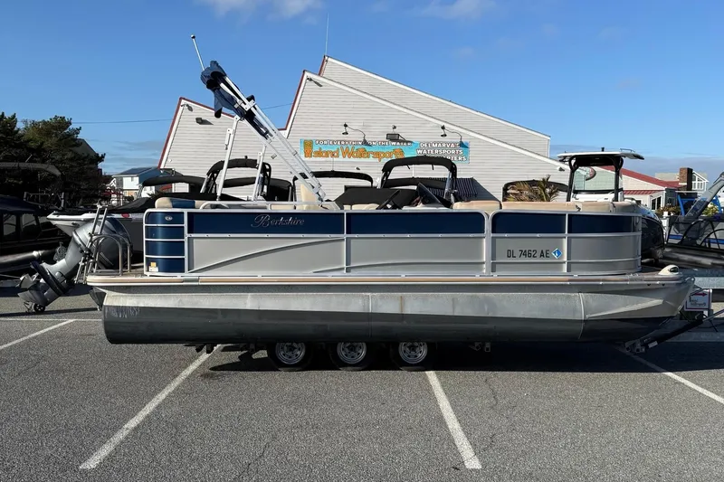 The Image of 2012 Berkshire 210CL Premium pontoon boat parked in a marina lot. - 1