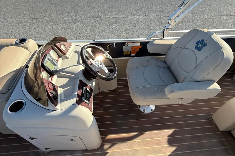 Slide: The Image of Captain's seat and helm of a 2012 Berkshire 210CL Premium pontoon boat. - 13