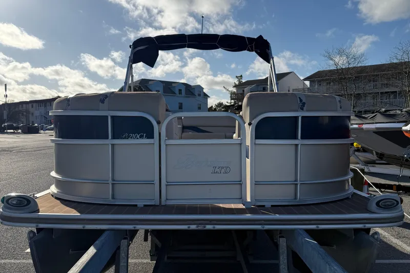 Slide: The Image of 2012 Berkshire 210CL Premium pontoon boat on trailer under a partly cloudy sky. - 3