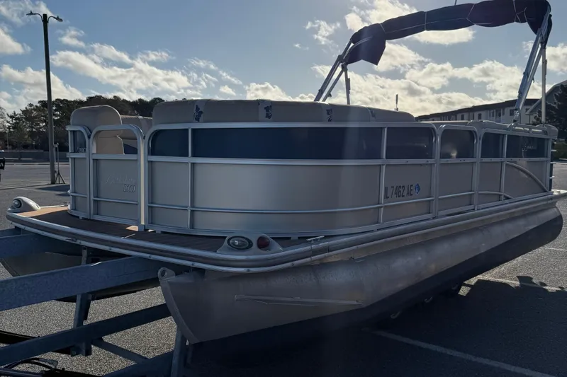 Slide: The Image of 2012 Berkshire 210CL Premium pontoon boat on trailer in parking lot. - 4
