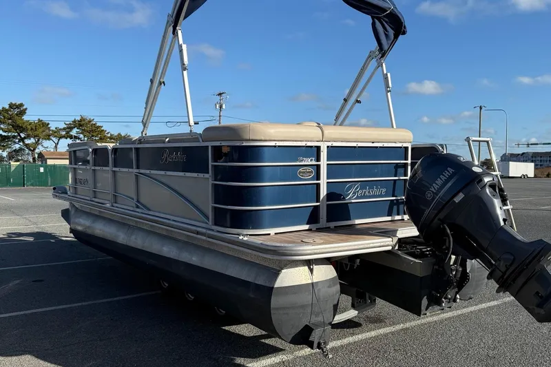 Slide: The Image of 2012 Berkshire 210CL Premium pontoon boat with Yamaha outboard motor in parking lot. - 6