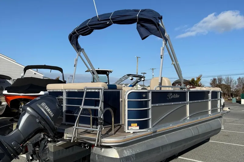 Slide: The Image of 2012 Berkshire 210CL Premium pontoon boat with Yamaha outboard motor in a parking lot. - 8