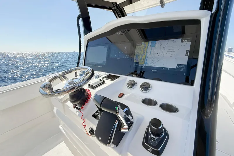 Slide: The Image of 2026 Blackwater 41 Sportfish helm with advanced navigation displays and controls, overlooking the ocean. - 46