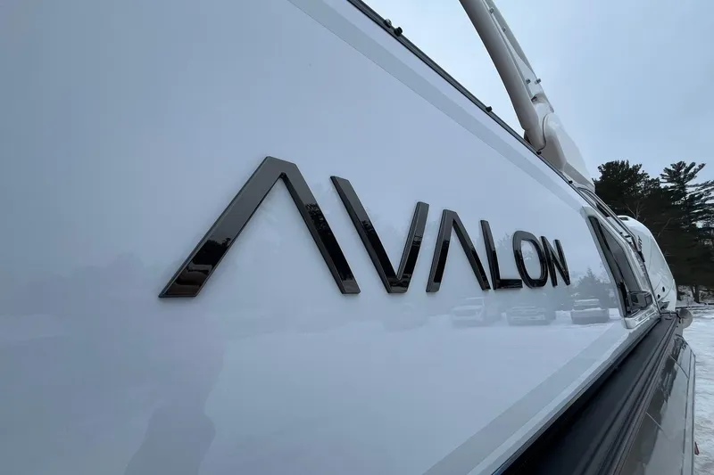 Slide: The Image of 2026 Avalon Excalibur LTD Quad Lounge boat with sleek design and logo. - 10