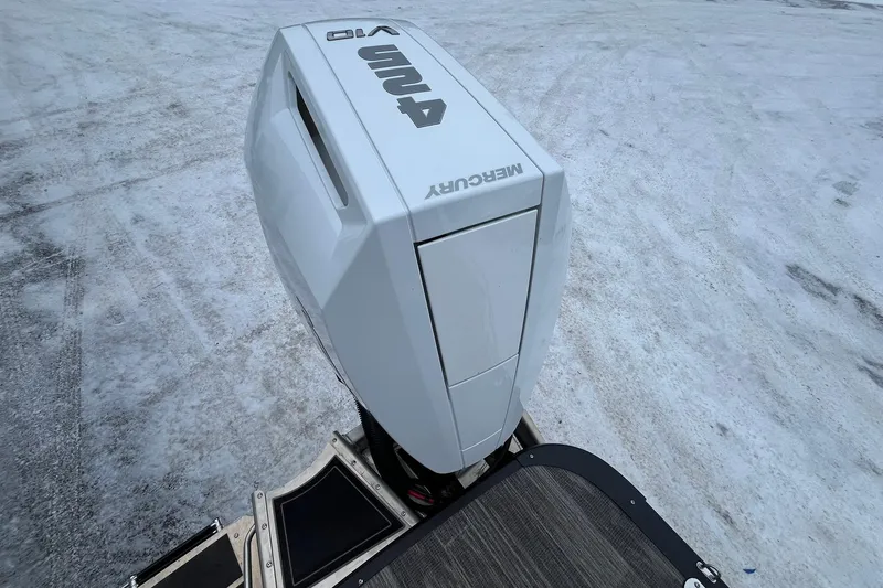 Slide: The Image of 2026 Avalon Excalibur LTD Quad Lounge with Mercury outboard engine on icy surface. - 22