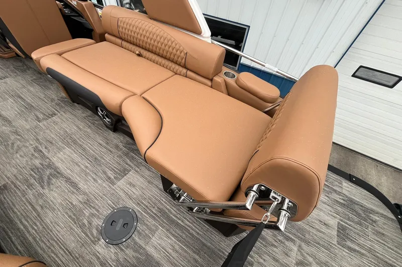 Slide: The Image of Luxurious seating on 2026 Avalon Excalibur LTD Quad Lounge boat, featuring tan upholstery and cup holders. - 26